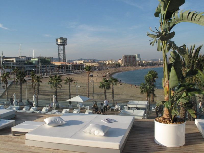 A terrace set for late afternoon above the cove